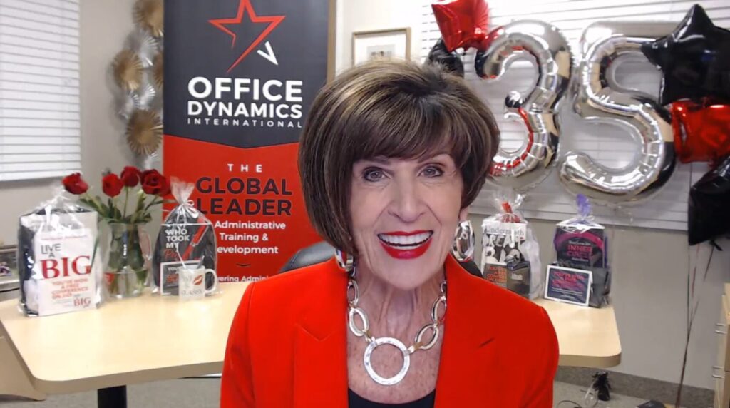 lessons for career growth - Joan Burge in a red suit sits in her office, presenting the 5 lessons webinar that this blog post was derived from